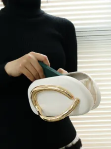 Detailed close-up view of the stylish white evening bag showcasing unique gold handle.