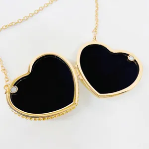Gold heart-shaped evening clutch bag with sparkling rhinestones and chain strap detail.