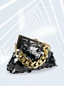 Detail view of a stunning black sequin evening clutch with chunky gold chain and metal frame.
