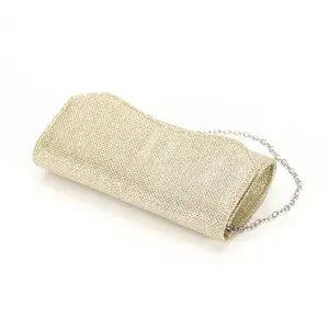 Detailed view of the gold glitter evening clutch bag featuring a delicate silver chain.