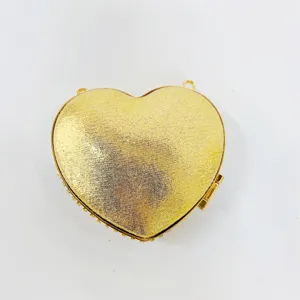 Elegant gold heart-shaped evening clutch bag, sparkly metallic finish for party wedding.