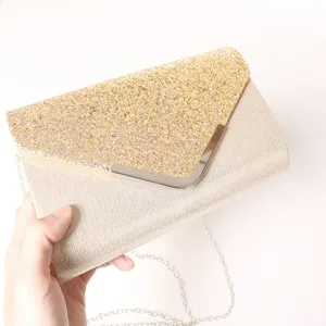 Elegant gold glitter evening clutch bag with chic metal V clasp and stylish chain shoulder strap.