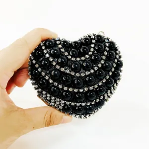 Stunning heart-shaped evening clutch bag adorned with black pearls and sparkling rhinestones.