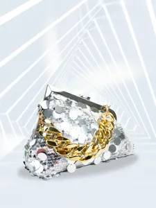 Detailed shot of a glamorous silver sequin evening clutch bag with chunky gold chain strap.