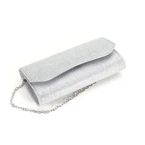 Silver glitter evening clutch bag detail showing sparkling texture and metal chain strap.