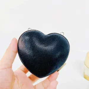 Elegant black heart shaped hard shell evening clutch bag with metal frame and strap for women.