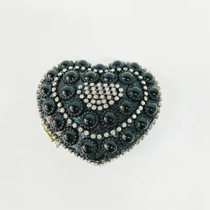 Close-up of black crystal heart evening bag featuring intricate beaded and rhinestone details.