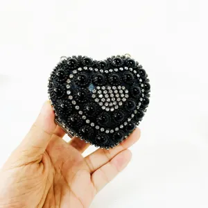 Exquisite black crystal heart evening clutch bag, detailed rhinestone and bead embellished surface.
