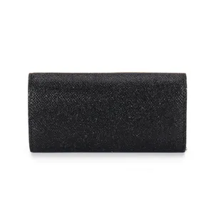 Close up detail of black glitter evening clutch bag, elegant shimmering material texture.