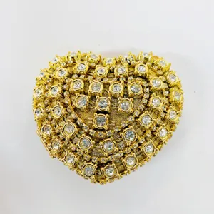 Detail shot of sparkly crystal heart evening clutch, gold-toned metal base, luxury bridal bag.