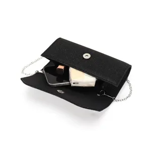Detailed view of black glitter evening clutch bag with chain strap and interior items.