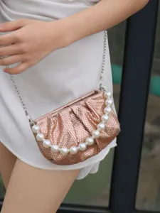 Stunning rhinestone evening clutch with elegant pearl handle and metallic finish, detail view.