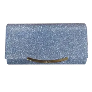 Exquisite blue glitter evening clutch bag detail featuring an elegant gold curved metal clasp.