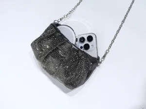 Detailed view of sparkling rhinestone evening clutch bag with chain strap and phone storage.