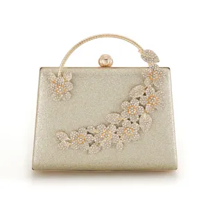 Elegant gold rhinestone evening clutch bag with sparkling floral and butterfly crystal details.