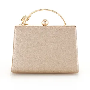 Exquisite gold glitter evening clutch bag featuring a metal handle and floral charm detail.