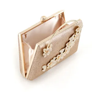 Gold glitter evening clutch bag featuring stunning rhinestone flower decoration and metal frame.
