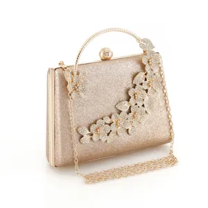 Elegant golden rhinestone evening clutch bag with metallic chain strap and stunning floral details.