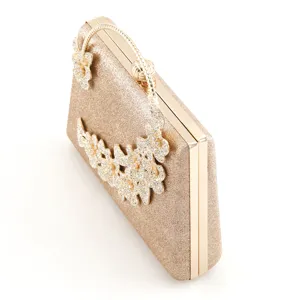 Gold glitter evening clutch bag featuring dazzling rhinestone floral details and metal frame.