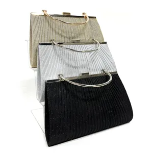 Close-up details of elegant pleated evening clutch bags with metal handles and secure lock design.