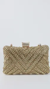 Closeup view of a glamorous gold rhinestone evening clutch bag with intricate crystal mesh design.