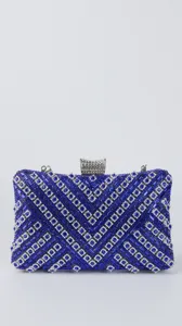 Stunning blue crystal evening clutch bag detail showing sparkling rhinestones and metal clasp.
