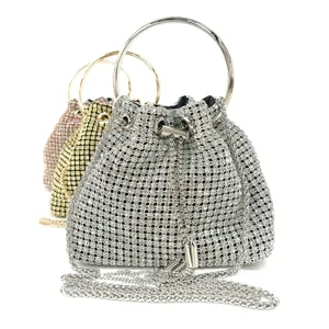 Sparkling rhinestone evening bucket bag with metal ring handle and chain strap detail.