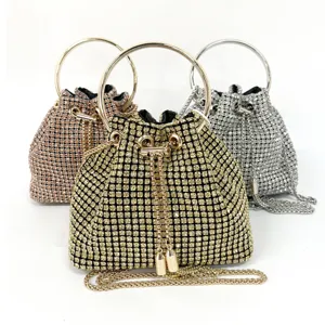 Elegant rhinestone evening bucket bag with metal ring handle and chain strap detail.
