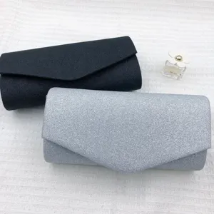 Detailed view of shimmering glitter evening clutch bags in black and silver, elegant style.
