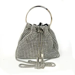 Detailed shot of the silver rhinestone evening bag showcasing metal ring handle and chain tassel.