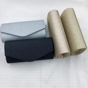 Glitter evening clutch bag detail showcasing stylish colors and sparkling finish for party wear.