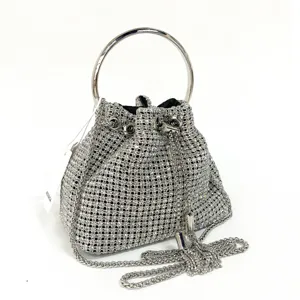 Silver rhinestone evening bucket bag with metal round handle and stylish chain strap detail.
