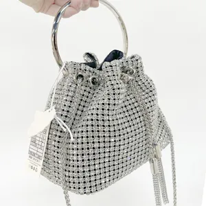 Sparkling rhinestone bucket bag detail, luxury evening handbag with metal ring handle.