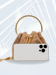 Detailed view of luxury rhinestone evening bag with metallic ring handle for party and banquets.