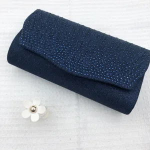 Sparkling dark blue pleated evening clutch bag with delicate rhinestone details for women.