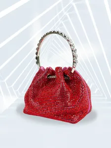 Detailed view of the sparkling red crystal evening bag with a glittering silver ring handle.