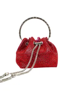 Red rhinestone bucket bag detail, sparkling evening purse with metal ring handle and chain.