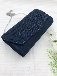 Detailed view of a dark blue rhinestone pleated evening clutch bag with chic silver chain strap.