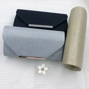 Details of glitter evening clutch bags, sleek metallic bar accent, elegant party style.