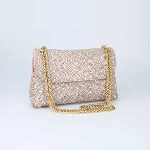 Detailed view of the sparkling rhinestone evening shoulder bag with gold chain strap. Luxury chic.