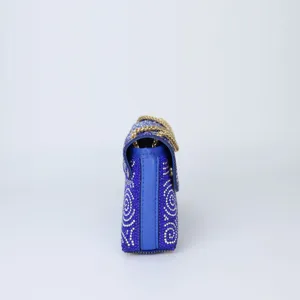 Side detail view of blue rhinestone evening bag featuring glittering crystals and chain