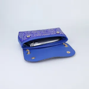 Detail view of the elegant blue rhinestone evening clutch bag with sparkling crystals and chain.