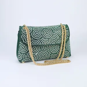 Green rhinestone evening bag detail, sparkling crystal shoulder bag with gold chain strap.