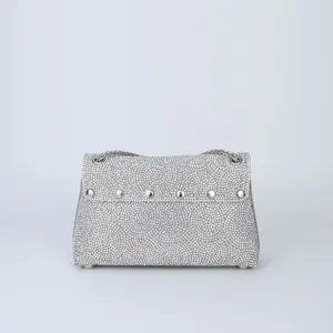 Detailed view of the sparkling rhinestone shoulder bag, featuring silver studs and delicate chain.