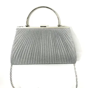 Silver pleated evening clutch bag with round metal handle and chain strap for women parties.