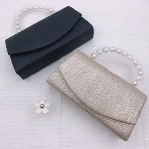 Elegant evening clutch bag set with pearl handle, perfect for weddings and parties.