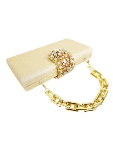Gold glitter evening clutch bag detail showing exquisite crystal rhinestone clasp and metal chain.