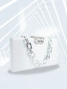 Silver glitter evening clutch bag detail showing rhinestone clasp and chunky chain strap.