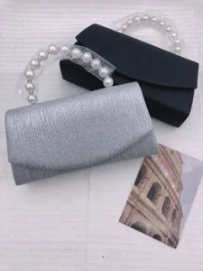 Elegant pearl handle evening clutch bag set, versatile silver and black bridal bags.