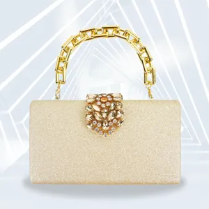 Elegant gold glitter evening clutch bag with chunky chain handle and crystal clasp for party.